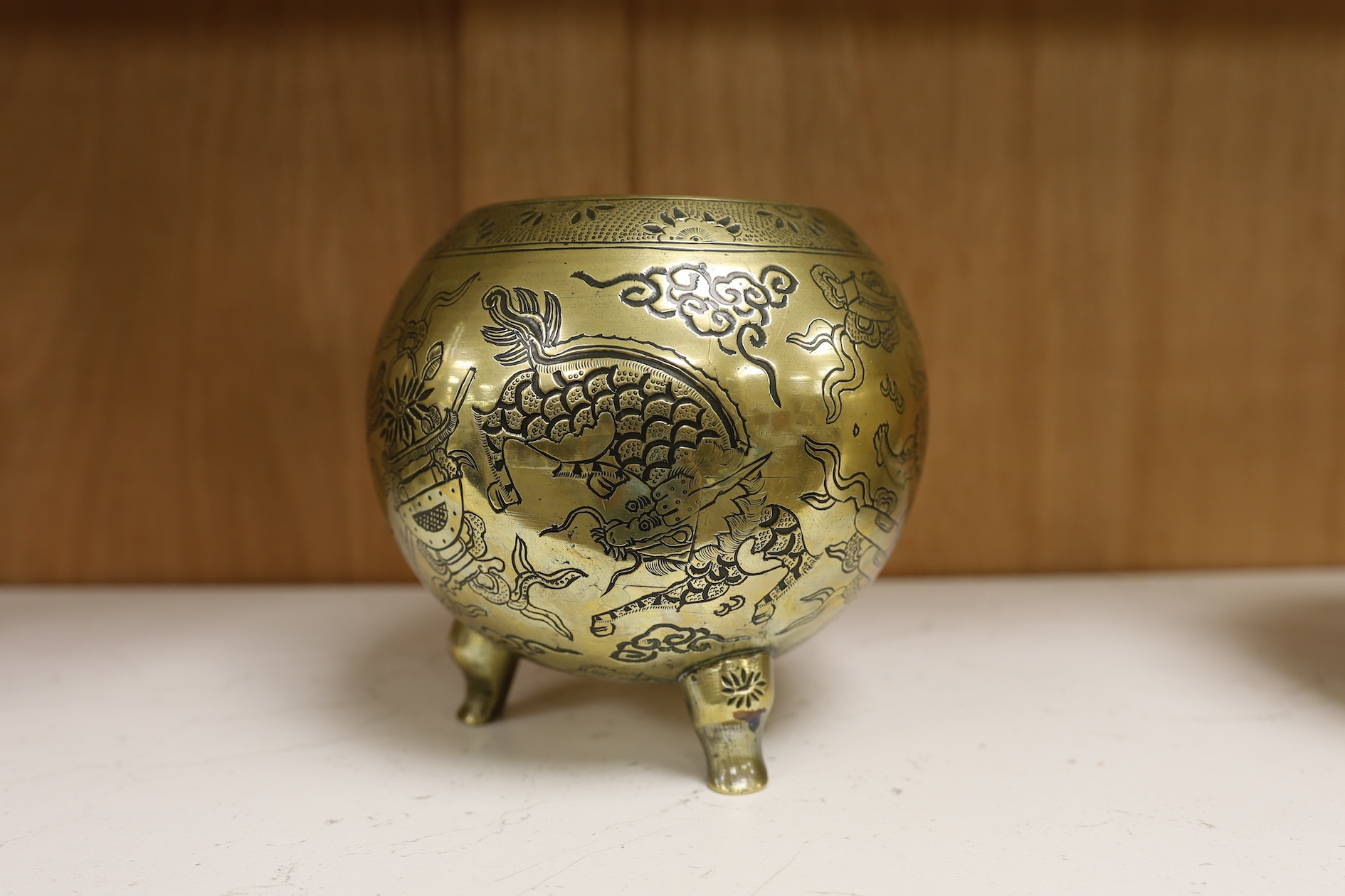 A Chinese bronze globular dragon decorated censer and cover on three legs, Xuande mark, early 20th century, 20cm high. Condition - good